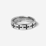 Silver ring with black cross designs on a white background