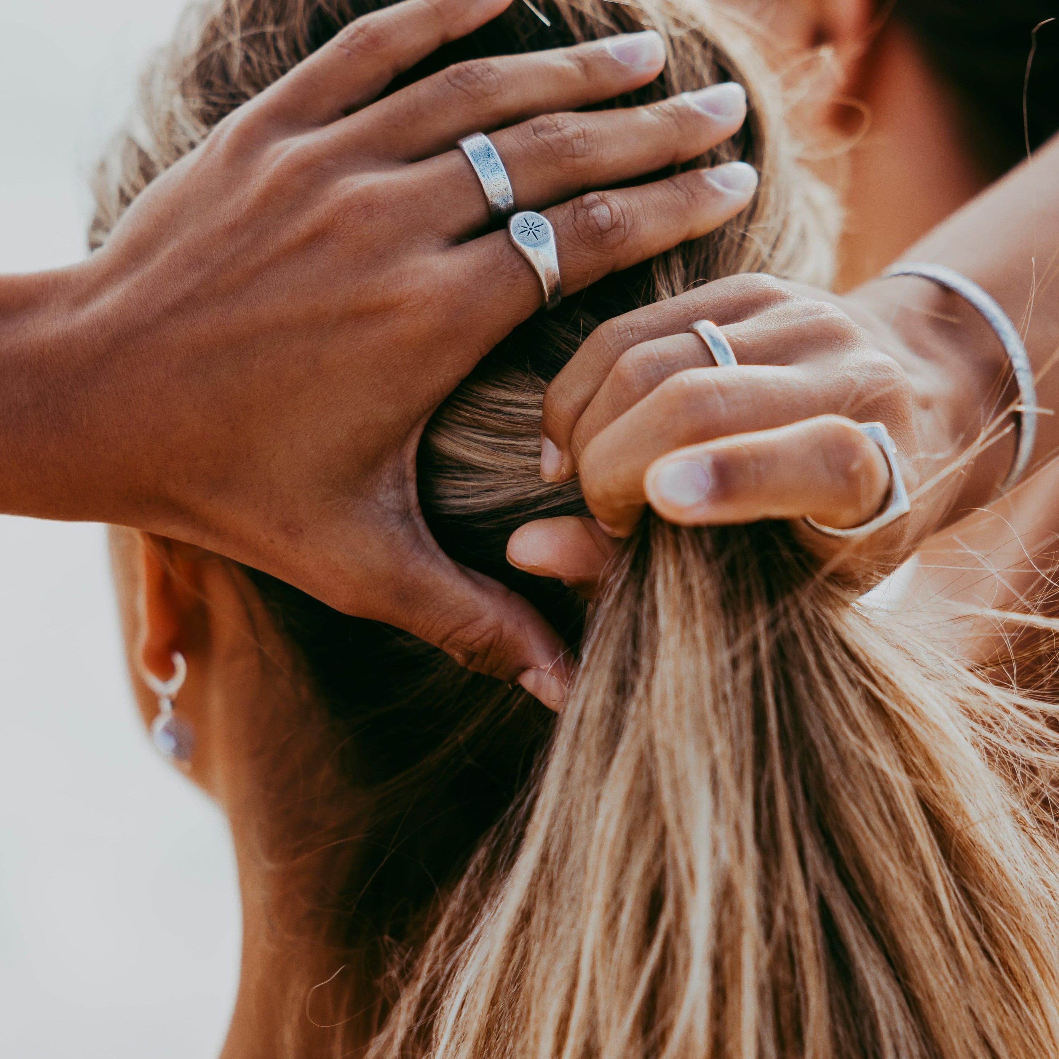 Pendant necklace styled on neutral knitwear